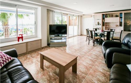a living room with a couch and a tv and a table at Nice Apartment In Santa Pola in Santa Pola