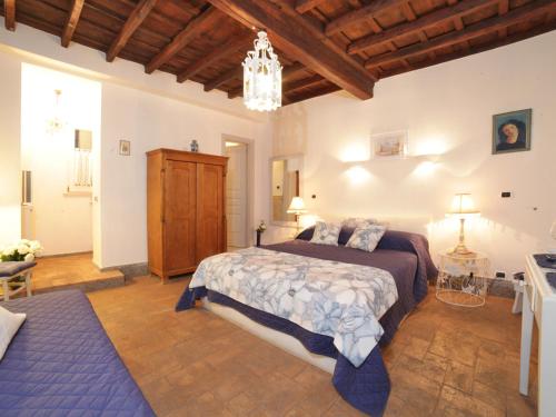 a bedroom with a large bed and a chandelier at Nostromondo Apartments Rome City Centre in Rome