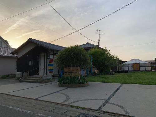 a house with a sign in front of it at 民泊大森主屋 in Futami