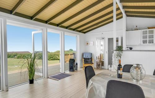 a dining room with a table and a large window at Amazing Home In Slagelse With Wifi in Slagelse