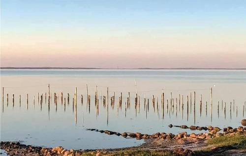 a large body of water with poles in the water at Lovely Home In Haderslev With Kitchen in Hejlsminde