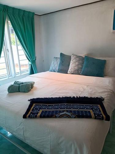 a bedroom with a large bed with a large window at Lumayan Guesthouse, Pantai Murni in Yan