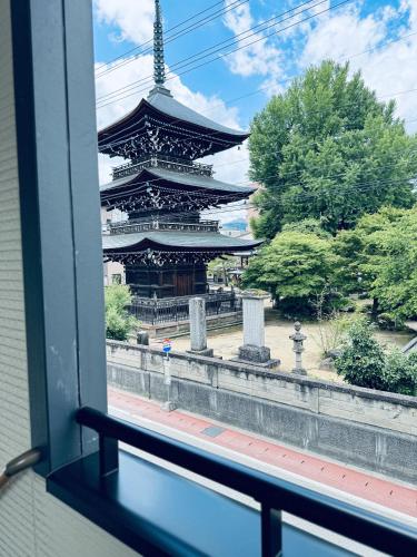 a view of a building from a window at Thanyaporn Hotel in Takayama