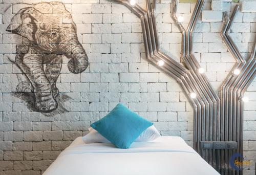 a bedroom with a wall with a drawing of an elephant at Sea Crest by Jomtien in Jomtien Beach