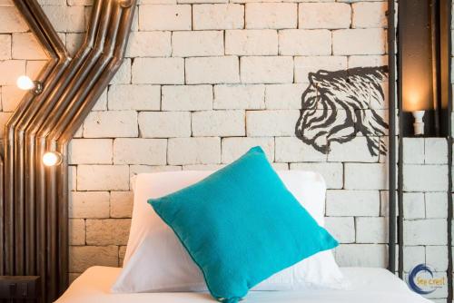 a blue pillow sitting on a bed with a wall at Sea Crest by Jomtien in Jomtien Beach