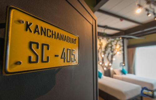 a yellow sign on the wall of a room with beds at Sea Crest by Jomtien in Jomtien Beach