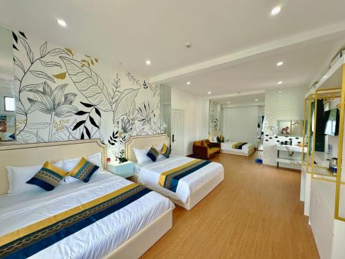 a bedroom with two beds and a living room at Sky Star 3 Hotel in Can Tho