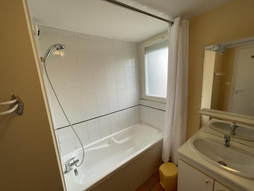 a bathroom with a shower and a tub and a sink at Appartement spacieux avec animaux admis et parking gratuit - FR-1-787-18 in Saint-Jacques-des-Blats