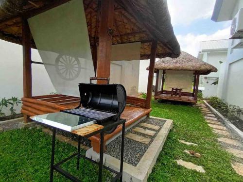 a grill in front of a gazebo at Romantic, Comfy Loft with Private Onsen in Amadeo