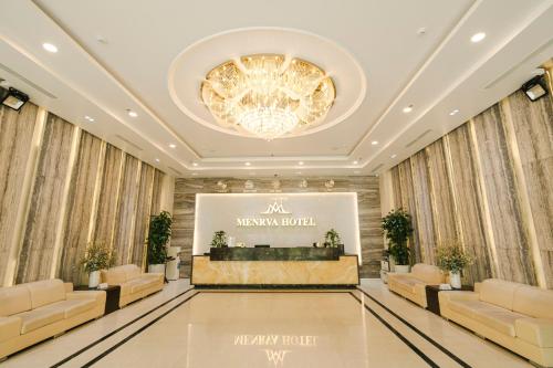 a lobby of a hotel with couches and a chandelier at Menrva Hotel in Hai Phong