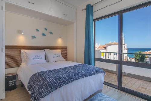 Postel nebo postele na pokoji v ubytování Vila Luz Mar