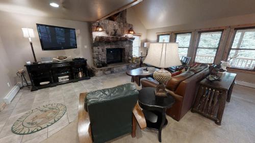 a living room with a couch and a fireplace at Antlers Riverside Lodge in Red River