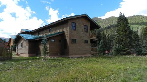 a house in the middle of a field at Antlers Riverside Lodge in Red River