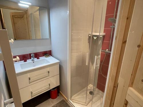 une salle de bain avec un lavabo et une douche dans l'établissement **Appartement T3 avec Terrasse, Parking et Proche Pistes** - FR-1-787-48, à Laveissière