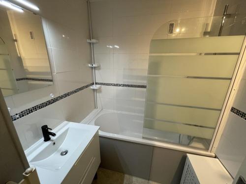 une salle de bain avec un lavabo, une baignoire et une douche dans l'établissement Studio en centre station avec balcon, WiFi - FR-1-787-71, à Laveissière