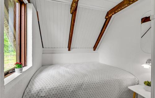 a bed in a small room with a window at Beautiful Home In Løgstrup With Wifi in Løgstrup