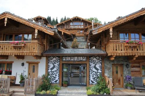 a log building with a sign in front of it at Chalet Promi-Alm in Flachau in Flachau