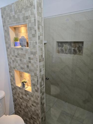 a bathroom with a shower with a glass door at Casa Hotel Victoria Real in Mariquita
