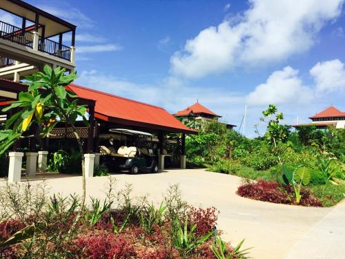 a resort with a car parked in a driveway at Eden Island P238A13 Lux Apartment in Mahe