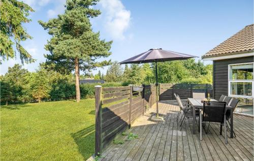 a patio with a table and an umbrella at Holiday Home Pengeurtvej Vordingborg V in Vordingborg