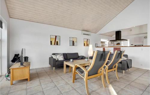 a living room with a table and chairs and a couch at Holiday Home Pengeurtvej Vordingborg V in Vordingborg