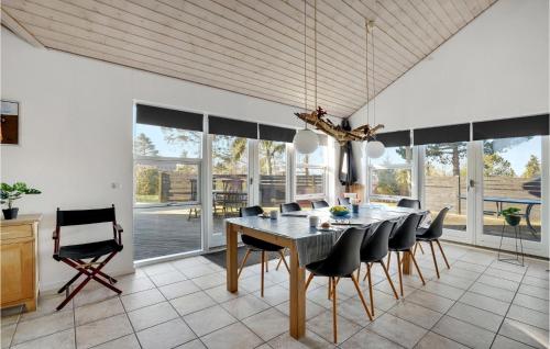 a dining room with a table and chairs at Holiday Home Pengeurtvej Vordingborg V in Vordingborg