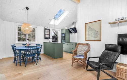 a kitchen and dining room with a table and chairs at Amazing Home In Nexø With Kitchen in Neksø