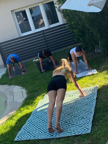 a group of people standing on a blanket in the grass at Apartments Bego Spa & Wellness in Crikvenica