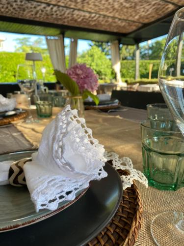 a table with a plate with a glass of wine at Apartments Bego Spa & Wellness in Crikvenica