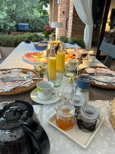 a table with plates of food and drinks on it at Apartments Bego Spa & Wellness in Crikvenica