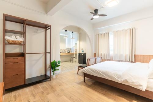 a bedroom with a bed and a chair at Baan Old Town Boutique Stay, Phuket Town in Phuket
