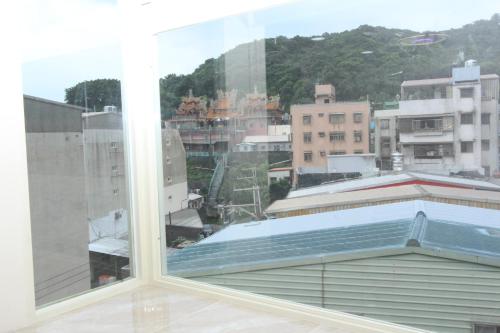 a large window with a view of a city at Sea Keelung in Keelung