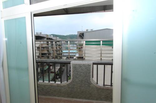 a balcony with a view of a building at Sea Keelung in Keelung