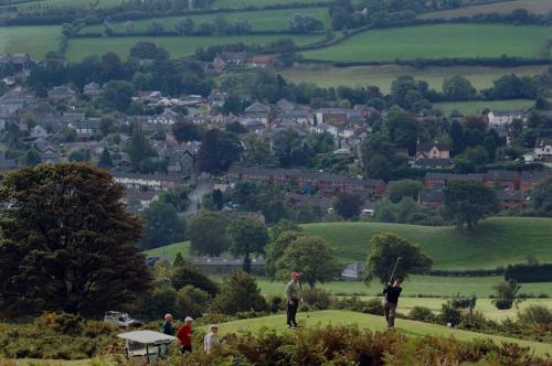 a group of people playing golf on a hill at Burton Hotel in Kington