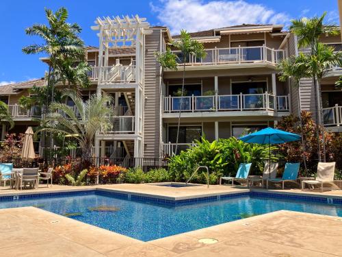a resort with a swimming pool and a building at Cool & Quiet Wailea Oasis, Big Lanai + Two Pools in Wailea