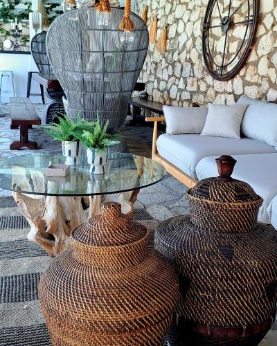 a living room with a glass table and two vases at Luxury Villa Athina in Nikiana