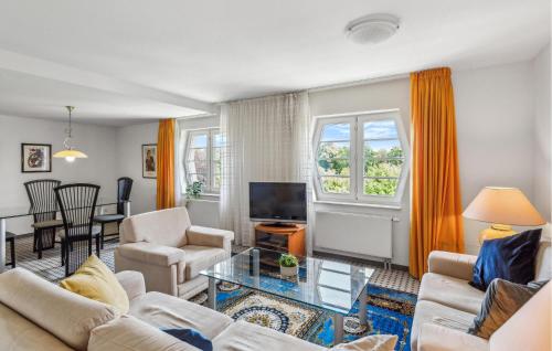 a living room with a couch and a tv at Lovely Apartment In Kühlungsborn in Kühlungsborn