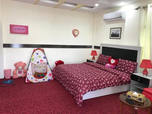 a bedroom with a bed with a pink bedspread at SWAT HiLL ViEW RESORT-only for families in Swat