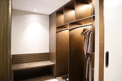 a walk in closet with wood paneling and a door at Castle Bayview Resort & Spa in Kampot