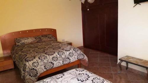 a small bedroom with a bed and a cabinet at Apartamento División del Norte Planta Alta in Matamoros