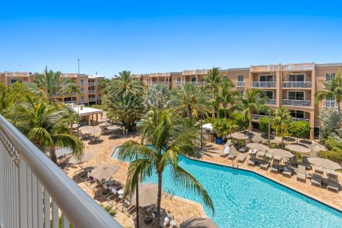an aerial view of a resort with a pool and palm trees at Beachside Resort & Residences in Key West