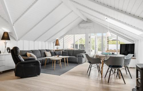 a living room with a couch and a table at Three-Bedroom Holiday Home In Ringkobing in Ringkøbing