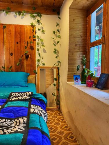 a bedroom with two beds in a room with a window at Canvas and Coffee in Kasol