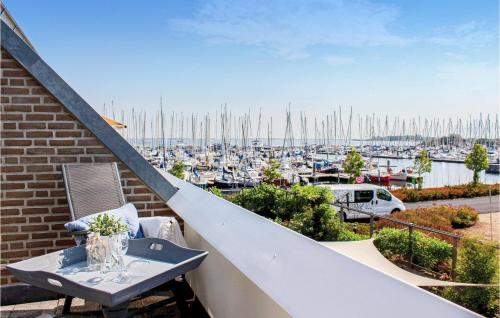 a balcony with a table and a view of a marina at 2 Bedroom Stunning Home In Bruinisse in Bruinisse
