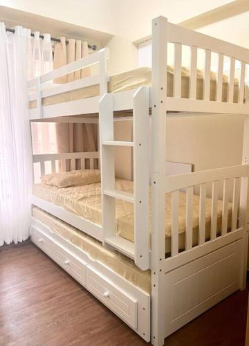 a white bunk bed in a room at Baguio Bliss Suites in Baguio