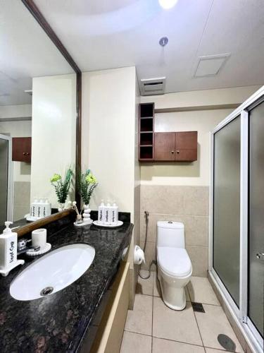 a bathroom with a sink and a toilet at Baguio Bliss Suites in Baguio