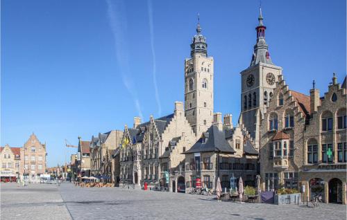 a building with two towers on a city street at Cozy Home In Merkem With Wifi in Merkem