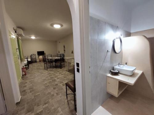 a bathroom with a sink and a table with chairs at Paesino in Kionia