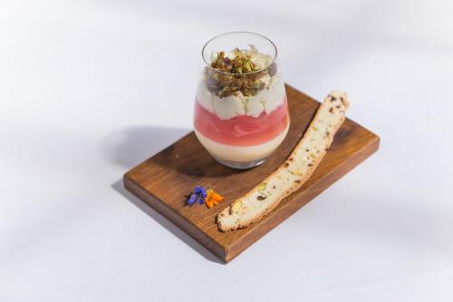 a wooden board with a drink and a stick of food at Tannery Townhouse in Dungarvan