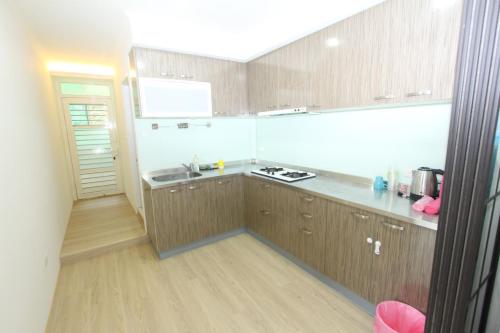 a kitchen with a sink and a counter top at Sea Keelung in Keelung